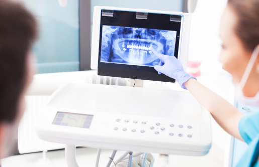 Dentist reviewing digital x-ray with patient at Wendy Sanger DMD Cosmetic + Family Dentistry